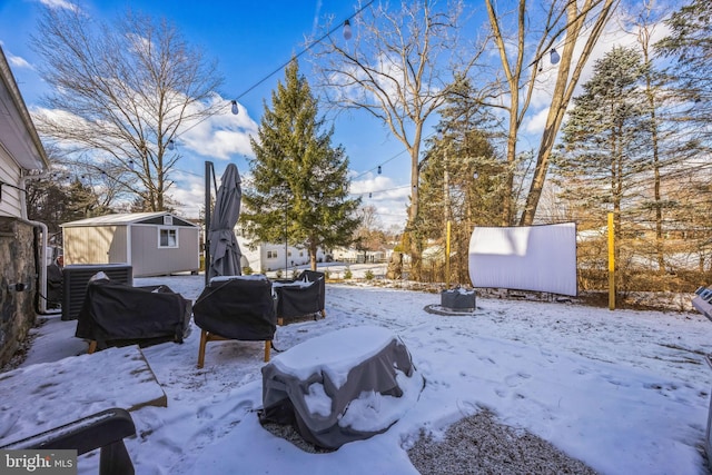 yard covered in snow featuring central air condition unit