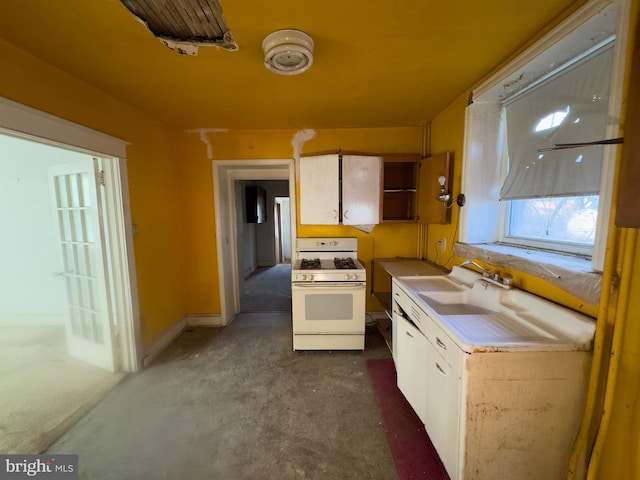 kitchen with white cabinetry, white range with gas cooktop, and sink