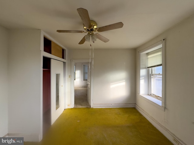 unfurnished bedroom with ceiling fan, light colored carpet, and a closet