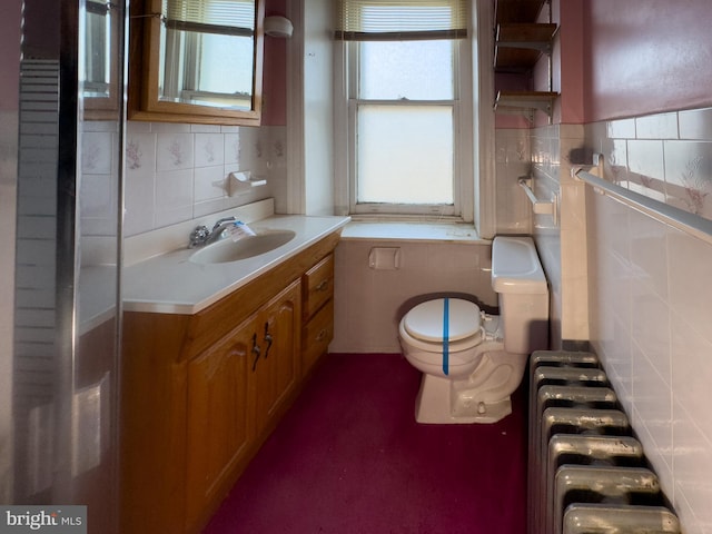 bathroom featuring radiator heating unit, vanity, and toilet