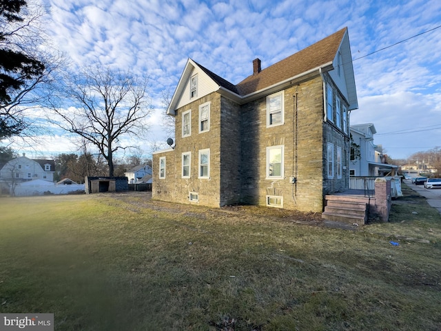 view of side of property featuring a yard