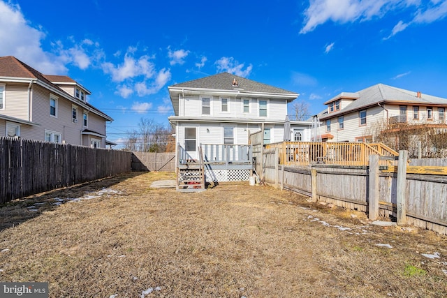 rear view of house with a wooden deck