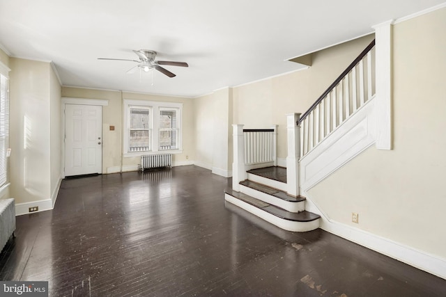 unfurnished living room featuring crown molding, ceiling fan, dark hardwood / wood-style flooring, and radiator