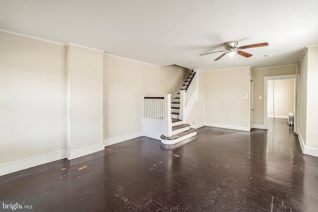 spare room featuring crown molding, dark wood-type flooring, and ceiling fan