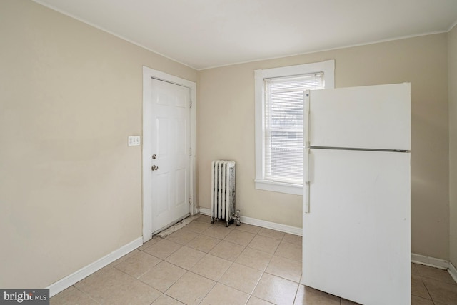 interior space featuring radiator, white fridge, and light tile patterned floors