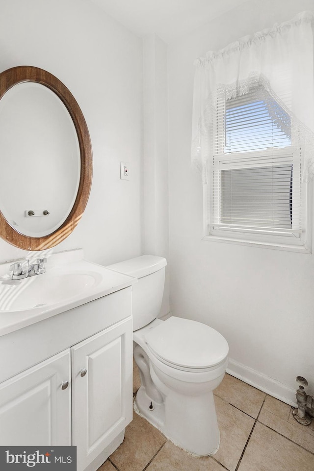 bathroom with vanity, tile patterned floors, and toilet