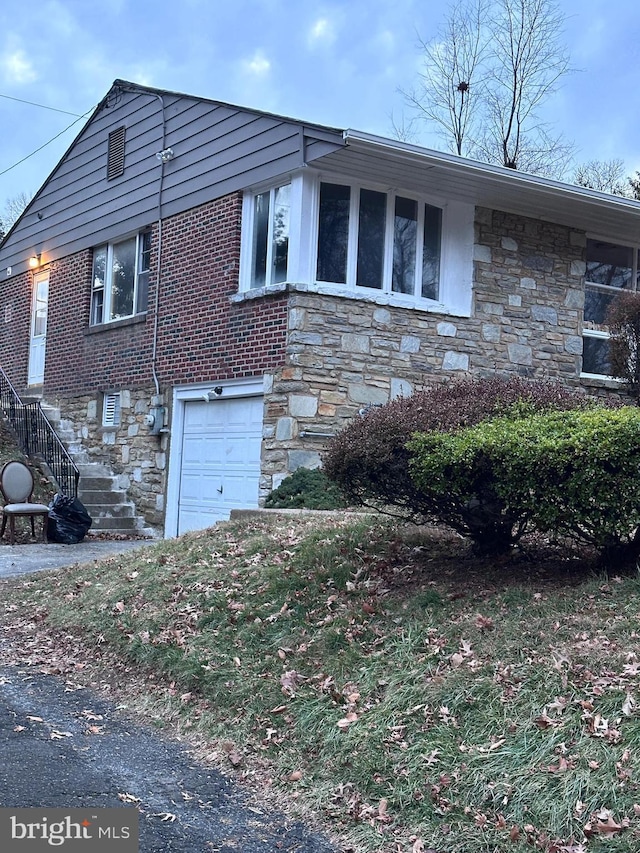 view of side of property with a garage