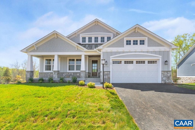 craftsman-style home featuring a porch, a garage, and a front yard