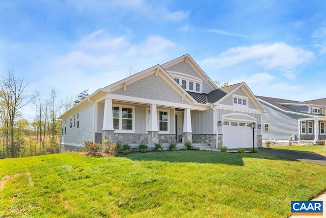 craftsman house with a porch, a garage, and a front yard