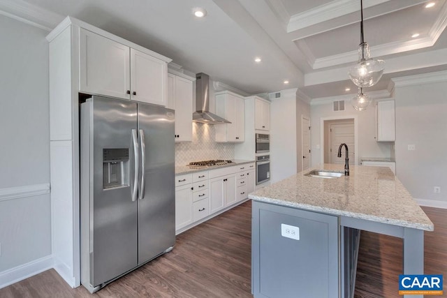 kitchen with white cabinets, an island with sink, wall chimney range hood, and appliances with stainless steel finishes