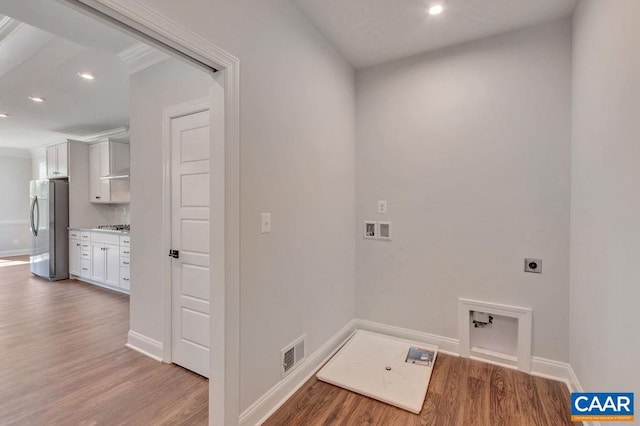 laundry room with hookup for an electric dryer, ornamental molding, hardwood / wood-style floors, and hookup for a washing machine