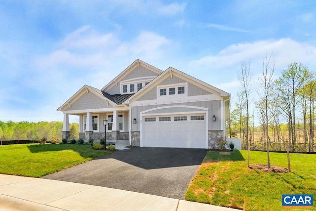 craftsman house featuring covered porch, a garage, and a front lawn