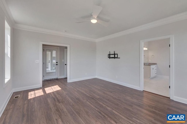 unfurnished room with dark wood-type flooring, plenty of natural light, ceiling fan, and ornamental molding