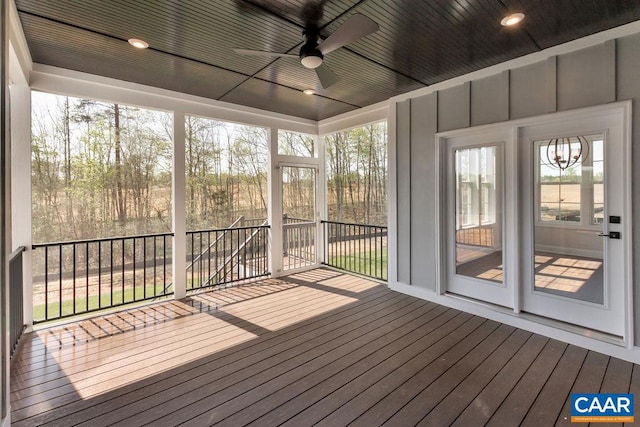 unfurnished sunroom with ceiling fan