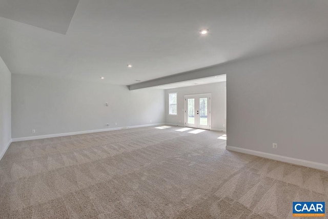 carpeted spare room with french doors