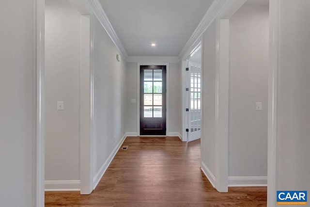 entryway featuring hardwood / wood-style floors and ornamental molding