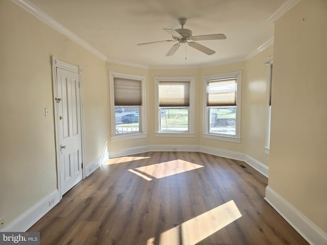 empty room featuring dark hardwood / wood-style flooring, ceiling fan, and crown molding