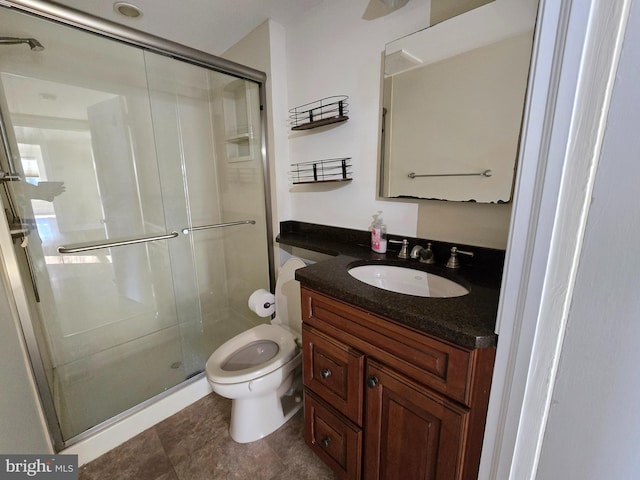 bathroom featuring vanity, toilet, and walk in shower