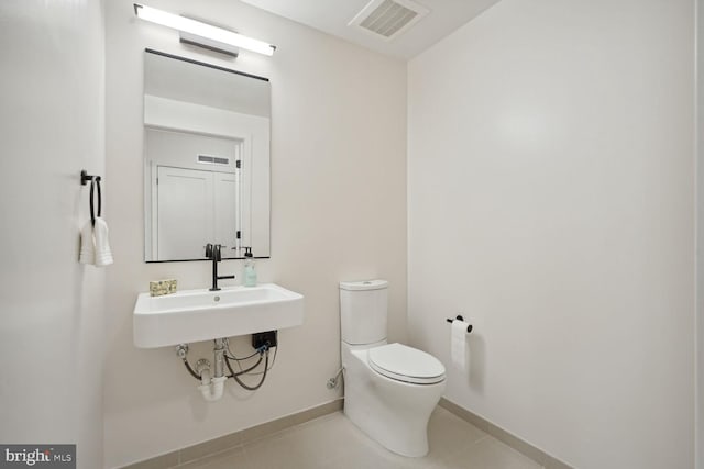 bathroom featuring tile patterned floors, sink, and toilet