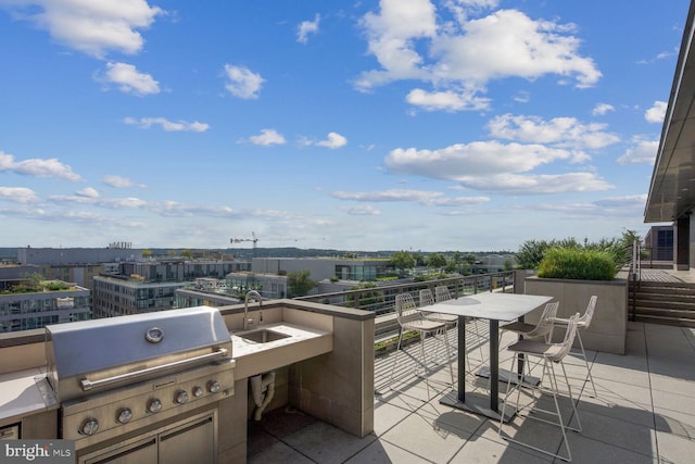 view of patio with area for grilling and sink