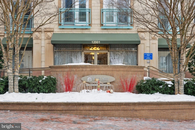 view of snow covered property entrance