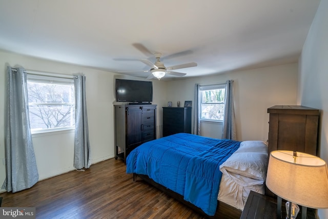 bedroom with ceiling fan and dark hardwood / wood-style floors