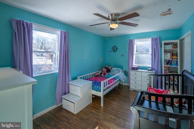 bedroom with ceiling fan and dark hardwood / wood-style flooring