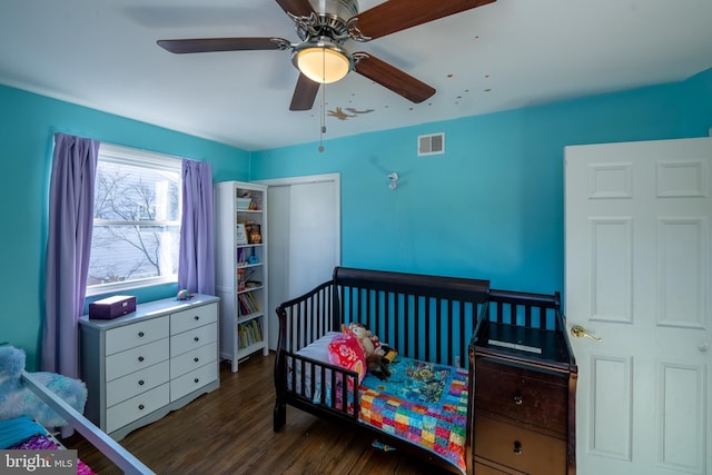 bedroom with ceiling fan and dark wood-type flooring