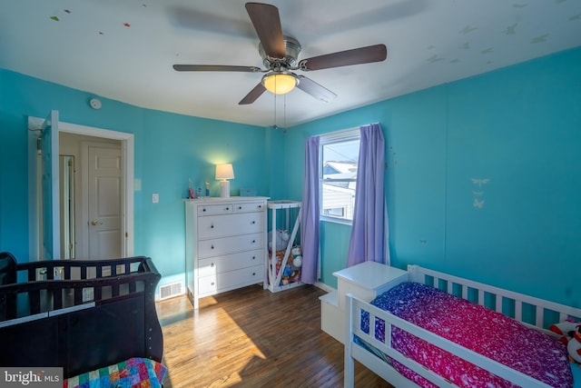 bedroom with ceiling fan and dark hardwood / wood-style flooring