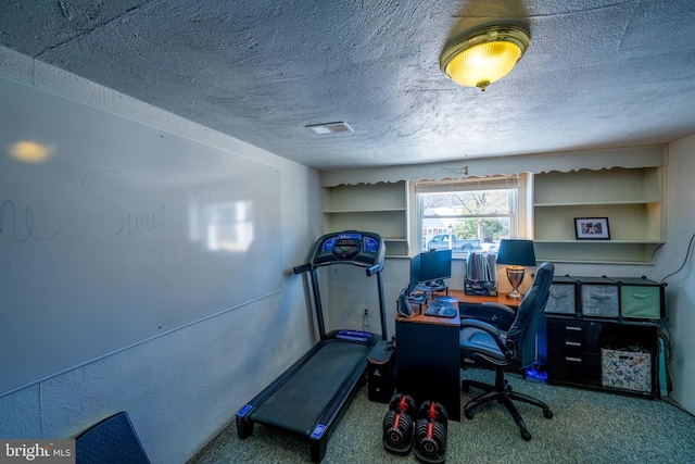 carpeted home office with a textured ceiling