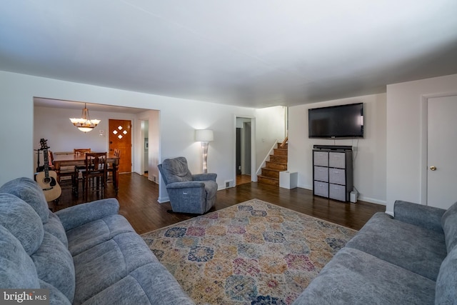 living room featuring dark hardwood / wood-style floors and a chandelier