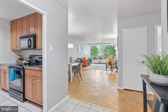 kitchen with light tile patterned floors and black appliances