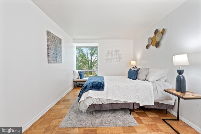 bedroom with light parquet flooring