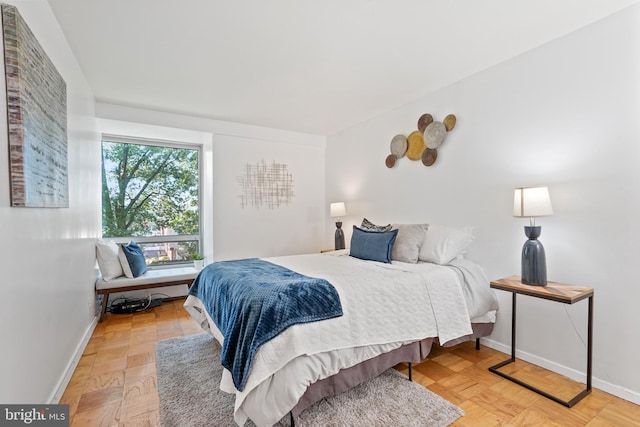 bedroom with light parquet floors