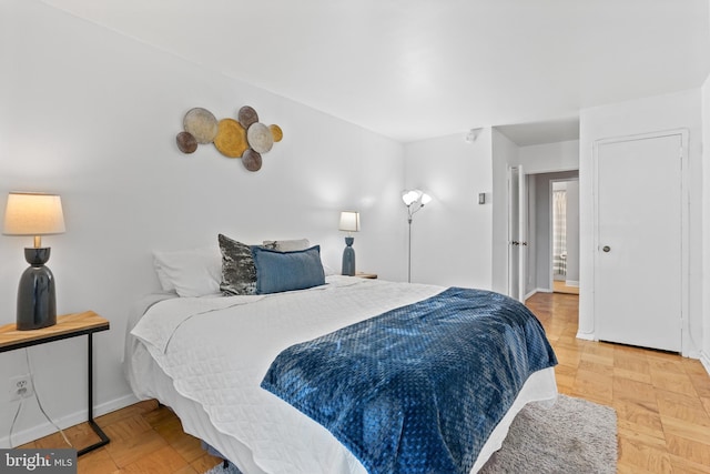 bedroom featuring parquet flooring