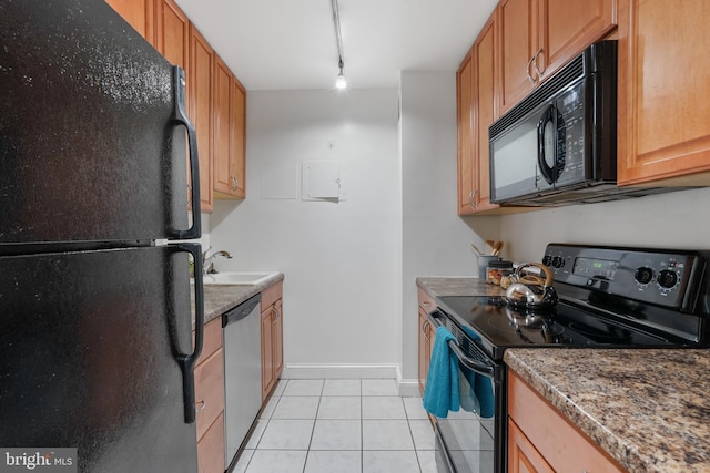 kitchen featuring black appliances, light tile patterned floors, sink, and track lighting