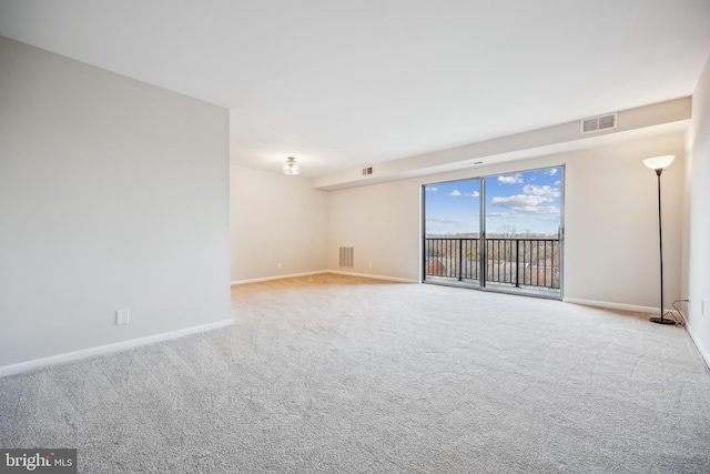 spare room featuring light colored carpet