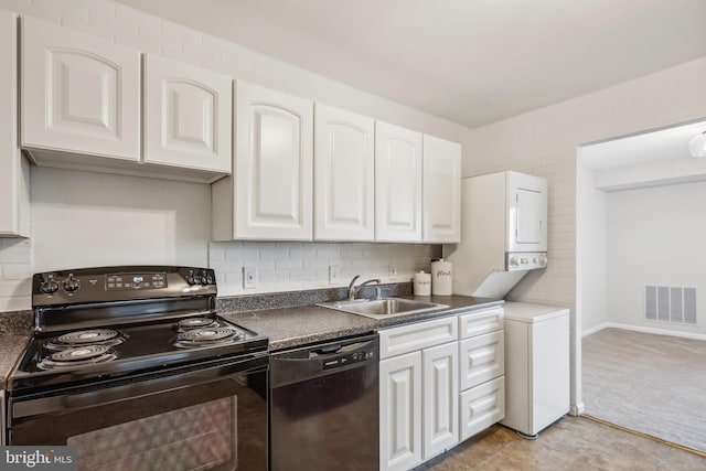 kitchen with black appliances, white cabinets, and sink