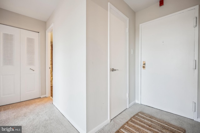 hall with light colored carpet