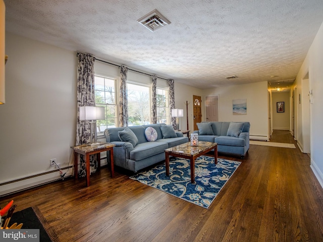 living room featuring a baseboard heating unit, a textured ceiling, and dark hardwood / wood-style floors