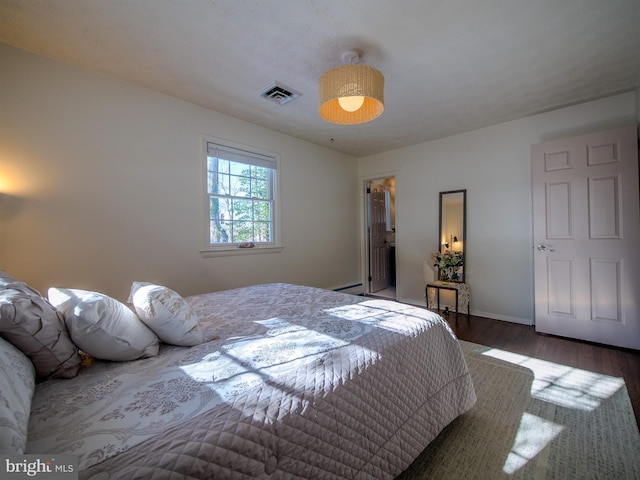 bedroom featuring a baseboard radiator and dark wood-type flooring