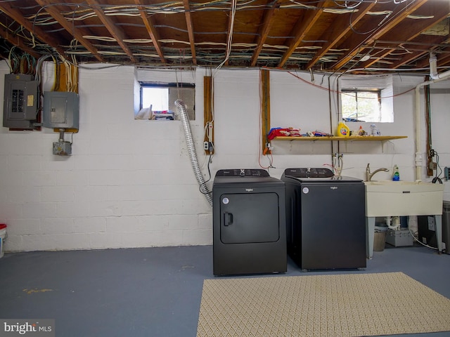 washroom featuring electric panel, sink, and washer and dryer