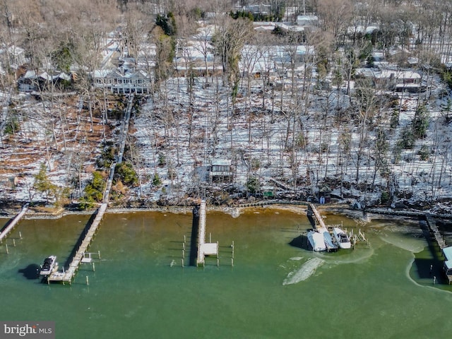 snowy aerial view featuring a water view