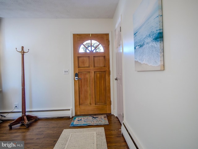 foyer with dark wood-type flooring, a textured ceiling, and baseboard heating