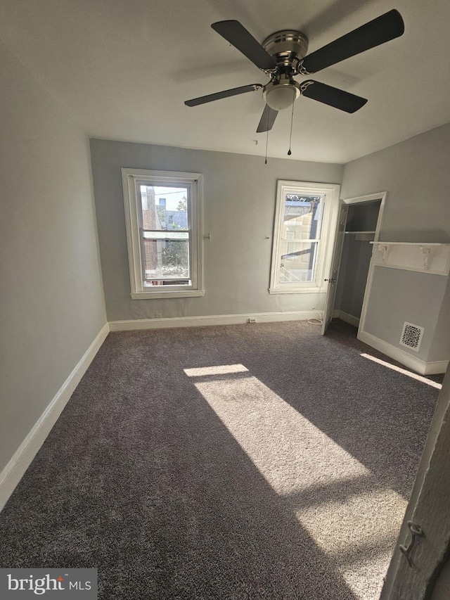 unfurnished bedroom featuring carpet, a closet, and ceiling fan