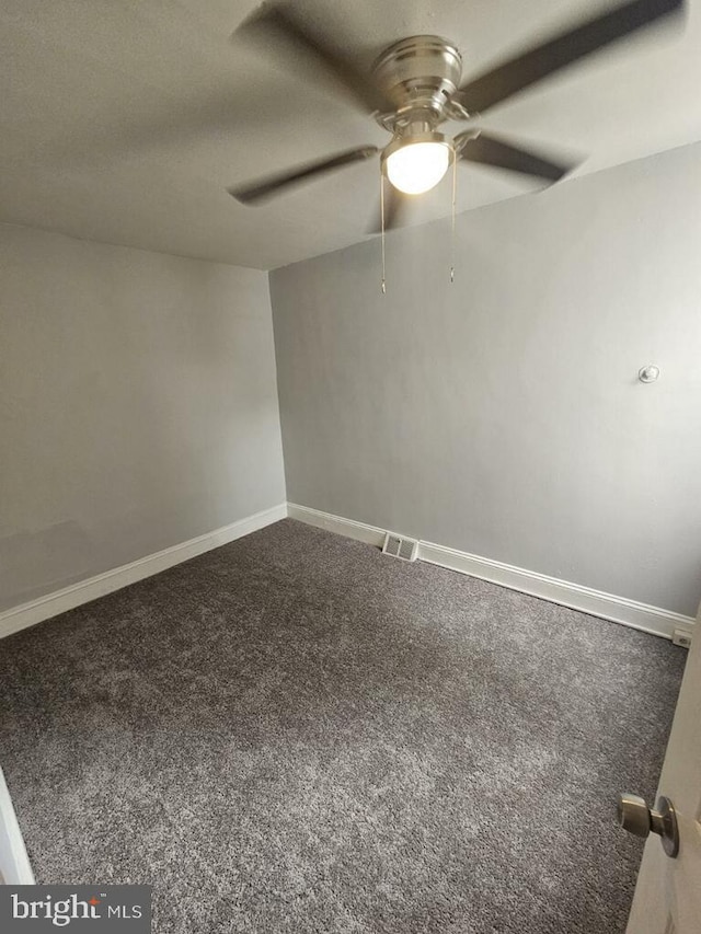 spare room featuring carpet and ceiling fan