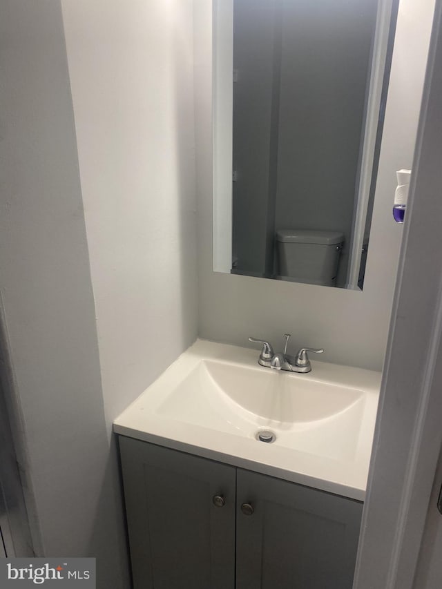 bathroom featuring vanity and toilet