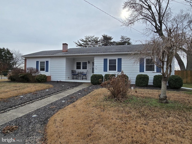 single story home with a patio and a front lawn