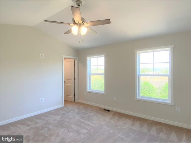 unfurnished room with light carpet, vaulted ceiling, and ceiling fan