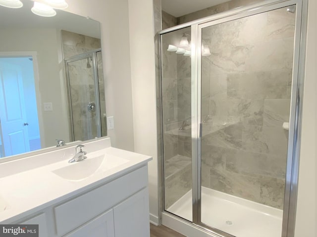 bathroom with vanity and a shower with shower door